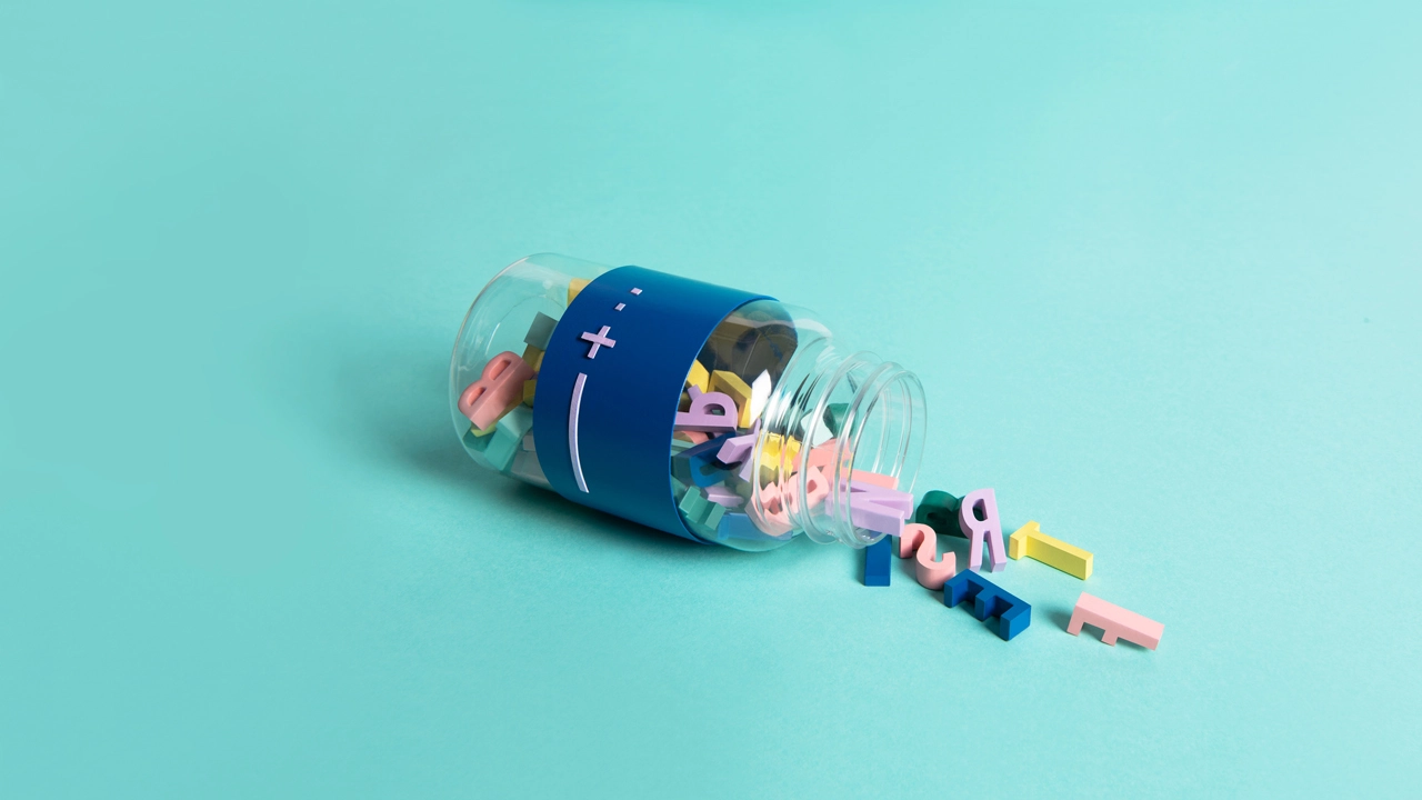 Photo of a medicine jar laying down with letters falling out